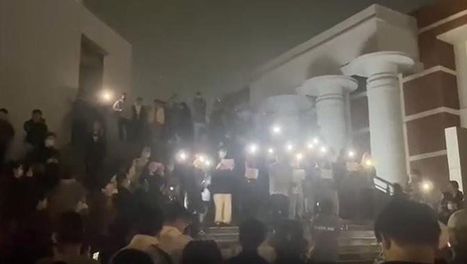 南京傳媒學院的大學生們舉白紙抗議中共，悼念新疆遇難者。