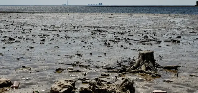 Draining reservoir from Ukraine's destroyed dam is revealing World War II weapons